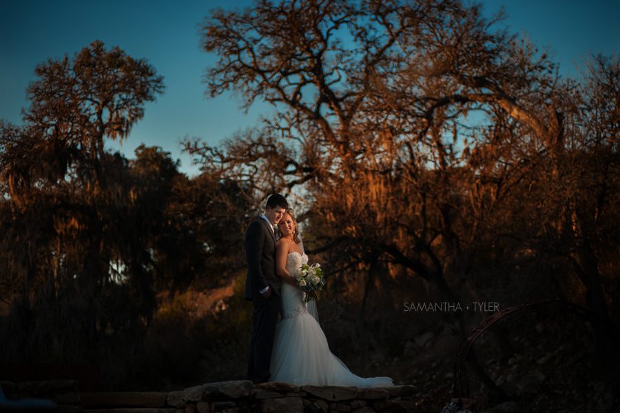 Samantha & Tyler got married on February 7, 2015 at the amazing Lodge at Bridal Veil Falls located in Spring Branch, TX. This was my first time out at this venue, and I must say that I am very impressed! I had heard a lot about this spot leading up to this date, and I was really looking forward to shooting out there. The venue was very well thought out, and is a wonderful place for a wedding. My favorite part of the Lodge is the bridal suite and the reception site. I love the size and layout of both spaces. It in amazing location for a picturesque party! Samantha & Tyler are a very nice couple couple, and their wedding was beautiful. I had an opportunity to get to know that both of them during their engagement & bridal sessions prior to the wedding. I always love shooting for my clients before their big day. I love the way that Samantha & Tyler's wedding day collection turned out. The first image in the series in a two image flash composite taken right around sunset time. The image was shot at 200mm with an old school 80-200 Nikon lens that rarely sees the light of day. The non treated glass gives the best colors out there, but is a little tricky to use. I am super happy that I broke it out and gave it a spin. I would like to give a special shout out to my lovely wife Kim for helping me out with this awesome wedding. She did a fabulous job as always! Anyways, here are my favorite shots from the day. Enjoy the preview and feel free to share them with your friends and family members. Congrats to Samantha & Tyler! Lodge at Bridal Veil Falls Wedding Photography - AJH Photography